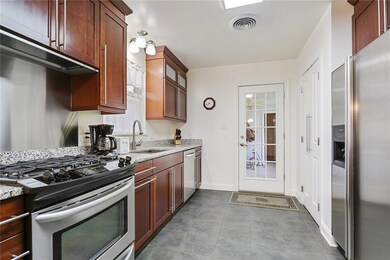The backdoor out of the kitchen leads to a covered