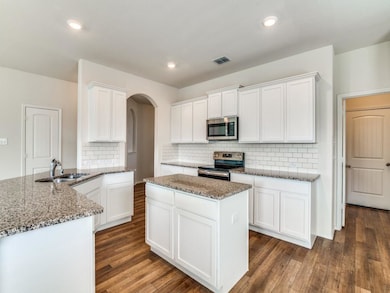 Stunning Kitchen with White Cabinets, Subway Tile Backsplash and California Breakfast Bar
