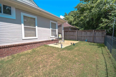 Fenced backyard with a patio