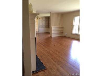 Living Room with picture window and fireplace, loo