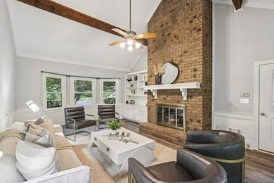 At the heart of the home is the Vaulted, Beamed Fireside Family Room with a Soaring Brick Fireplace as its centerpiece.