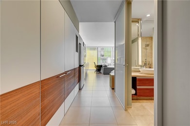 Hall featuring sink, light tile patterned flooring