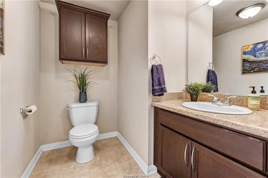 Bathroom featuring vanity and baseboards