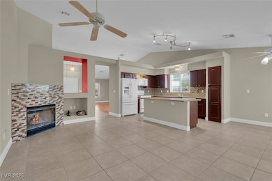 Kitchen featuring white appliances, vaulted ceilin