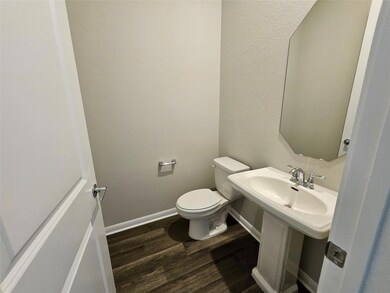 Bathroom with baseboards, wood finished floors, a