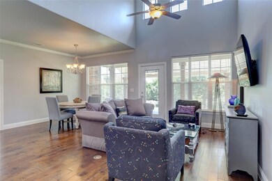 The open living area features soaring ceilings and