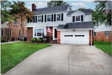 View of front of house with garage and a front yard