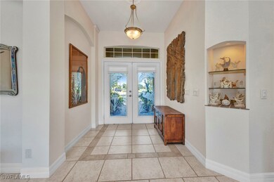 Entrance foyer with french doors and baseboards