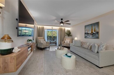 Living room with ceiling fan and light hardwood / 
