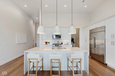 Kitchen featuring appliances with stainless steel GE Cafe appliances, and champagne bronze.