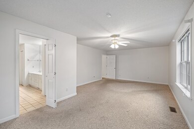 Spacious primary bedroom with a private bath.