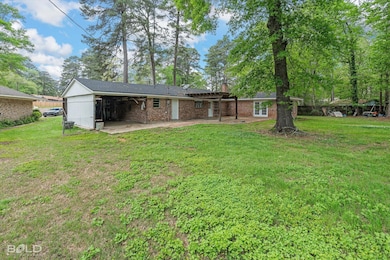Rear view of property featuring brick siding, an a