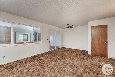 Living room with slider to back porch and door to side entry and basement.