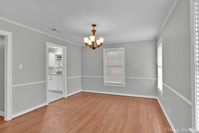 Tiled empty room featuring a notable chandelier, s