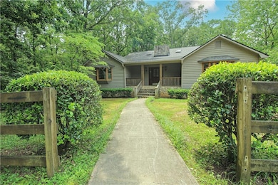 View of front of house with a porch and a shingled roof