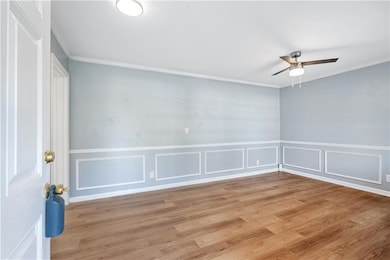 Unfurnished room featuring crown molding, light ha