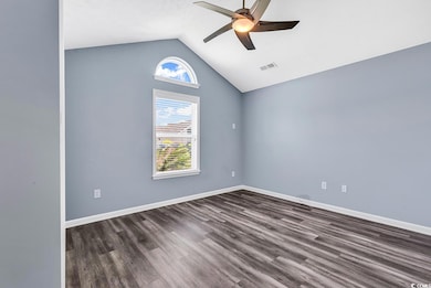 Unfurnished room with visible vents, a ceiling fan