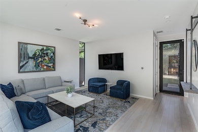 Living room with light wood-style floors, visible