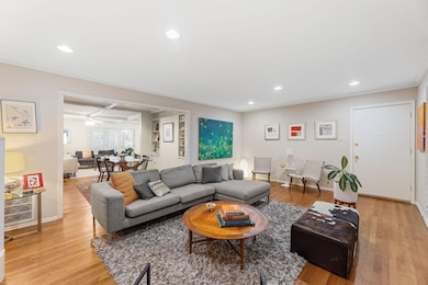 Living area featuring recessed lighting, light wood-type flooring, beam ceiling, and coffered ceiling