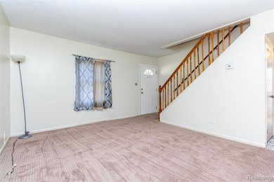 Entryway featuring stairs and carpet floors
