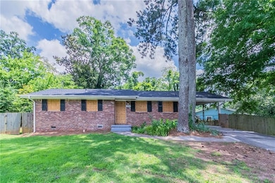 Ranch-style house with brick siding, crawl space, and concrete driveway