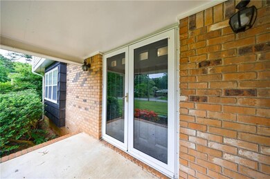 Doorway to property featuring brick siding