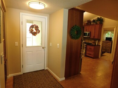 Formal entry with cork flooring and entry closet
