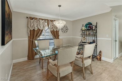 Dining space featuring a chandelier, light wood-st