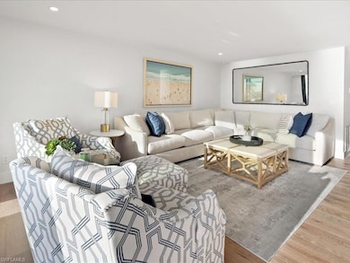 Living area featuring wood finished floors and recessed lighting