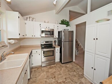 Painted wood cabinetry with new hardware and a dou
