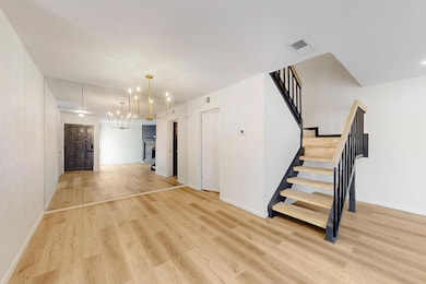 Unfurnished living room featuring visible vents, l
