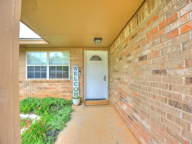 Entrance to property featuring brick siding