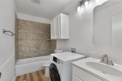 Bathroom featuring washer / dryer, wood finished 