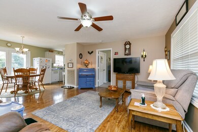 Living room, dining area and kitchen have quality hardwood laminate flooring.