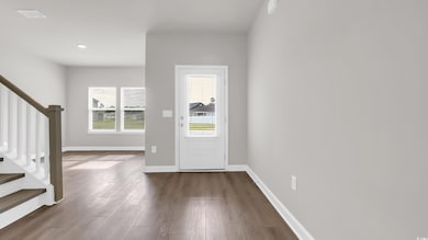 Foyer with stairs and dark wood-type flooring