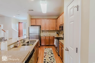 Kitchen with visible vents, a sink, appliances wit