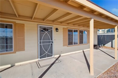 Doorway to property featuring a covered patio area