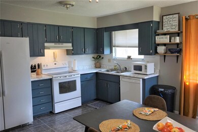 Cute eat in kitchen with many cabinets.