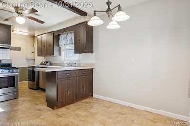 Kitchen with stainless steel gas range oven, light countertops, a peninsula, dark brown cabinetry, and tasteful backsplash