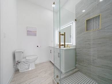 Primary Bath with glass enclosed shower with built