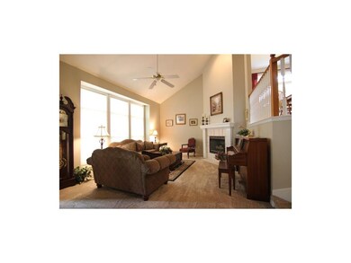 Vaulted Ceiling family room with a fireplace & Bli