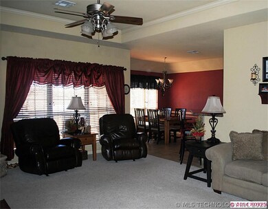 Den with open floor plan to the dining and kitchen