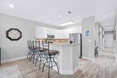 Kitchen featuring light wood-type flooring, backsp