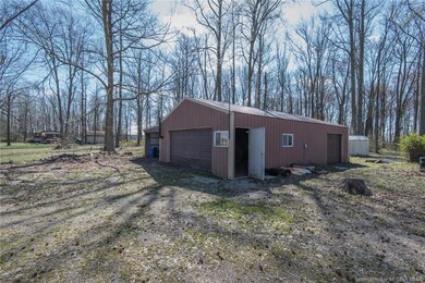 Pole barn with lean-tos, two overhead doors, wood 