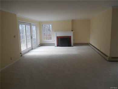 Large living room with gas fireplace. All new carp