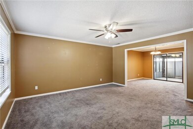 Living room with crown moulding.