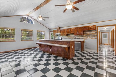 Kitchen featuring ceiling fan, a wealth of natural