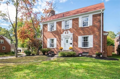 Colonial-style house with a front yard