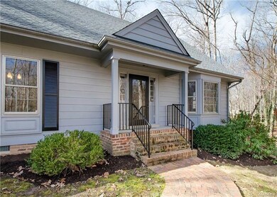 An attractive brick walkway leads to the covered e