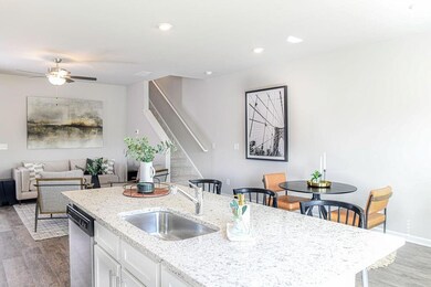 Kitchen featuring a sink, dark wood-style flooring